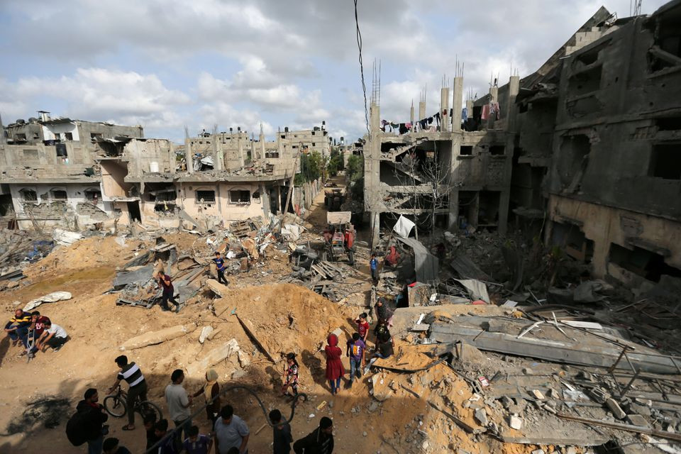 palestinians gather after returning to their houses which were destroyed by israeli strikes in the recent cross border violence between palestinian and israel following israel hamas truce in gaza photo reuters