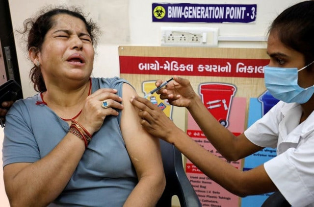 a woman reacts as she receives a dose of the covishield vaccine against the coronavirus disease covid 19 manufactured by serum institute of india at a vaccination centre in ahmedabad india october 21 2021 photo reuters a woman reacts as she receives a dose of the covishield vaccine against the coronavirus disease covid 19 manufactured by serum institute of india at a vaccination centre in ahmedabad india october 21 2021 photo reuters