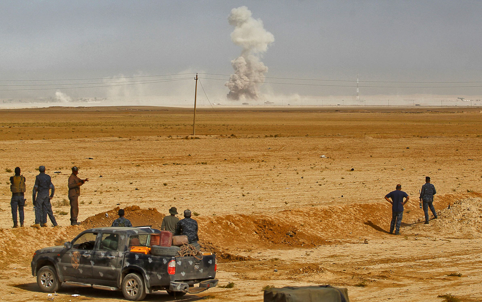 Smoke billows as Iraqi forces hold a position in the area of al-Shurah, some 45 kms south of Mosul, while advancing towards the city to retake it from the Islamic State (IS) group militants. PHOTO: AFP