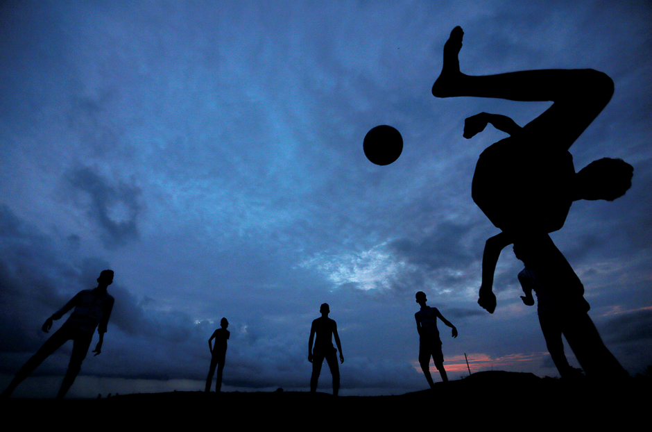 a boy kicks a ball as he plays soccer with his friends at galle dutch fort in galle sri lanka photo reuters