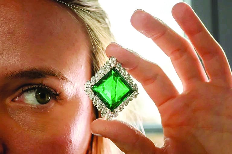 a christie s employee poses with emerald photo afp