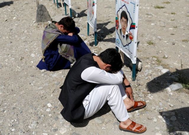 relatives gather at a graveyard of the victims who were killed in a suicide attack in an educational centre two years ago as afghan government officials and the taliban hold talks in doha aimed at ending 19 years of war in the country in kabul afghanistan september 14 2020 reuters