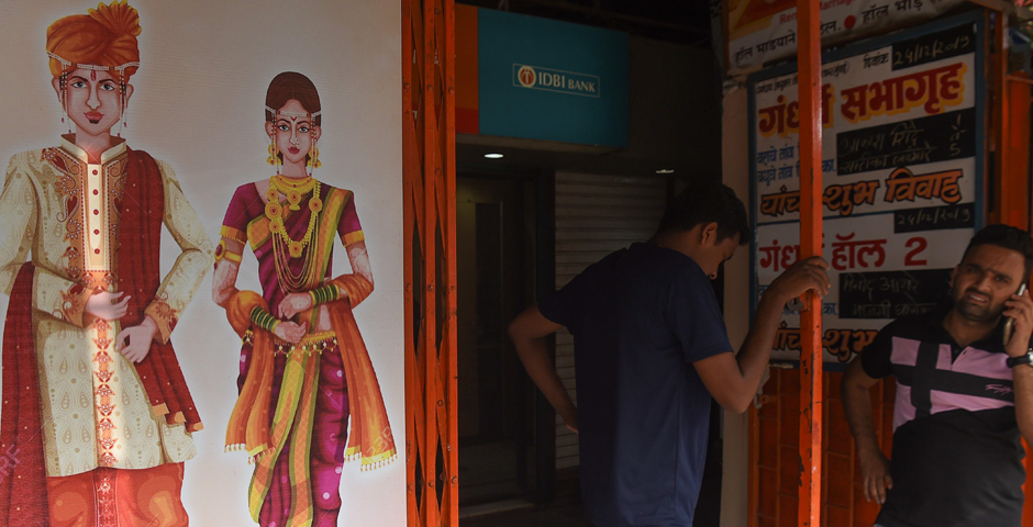 Relatives wait for the bride and groom at a marriage hall outside a family court in Mumbai. Photo: AFP