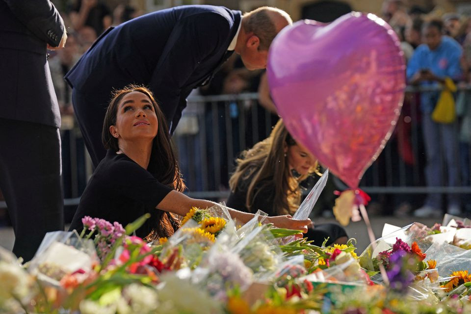 duchess of sussex look at floral tributes laid by members of the public at windsor castle on september 10 photo reuters