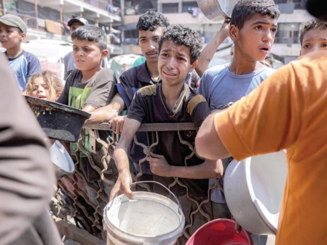 children queue with pots to receive meals from a charity kitchen in gaza photo afp children queue with pots to receive meals from a charity kitchen in gaza photo afp