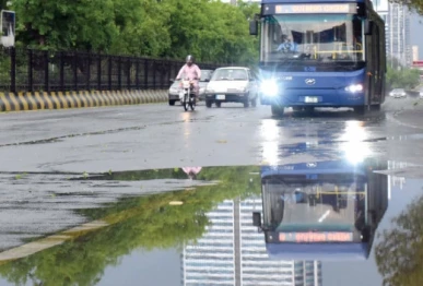 puddles along jinnah avenue mirror the refreshed greenery as rain brings welcome relief from the heat in the federal capital photo online