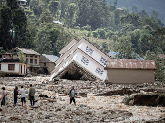 people walk along the damaged houses along the bank of roshi river at panauti in kavre nepal photo reuters people walk along the damaged houses along the bank of roshi river at panauti in kavre nepal photo reuters