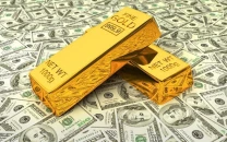 strong dollar rising yields push gold lower