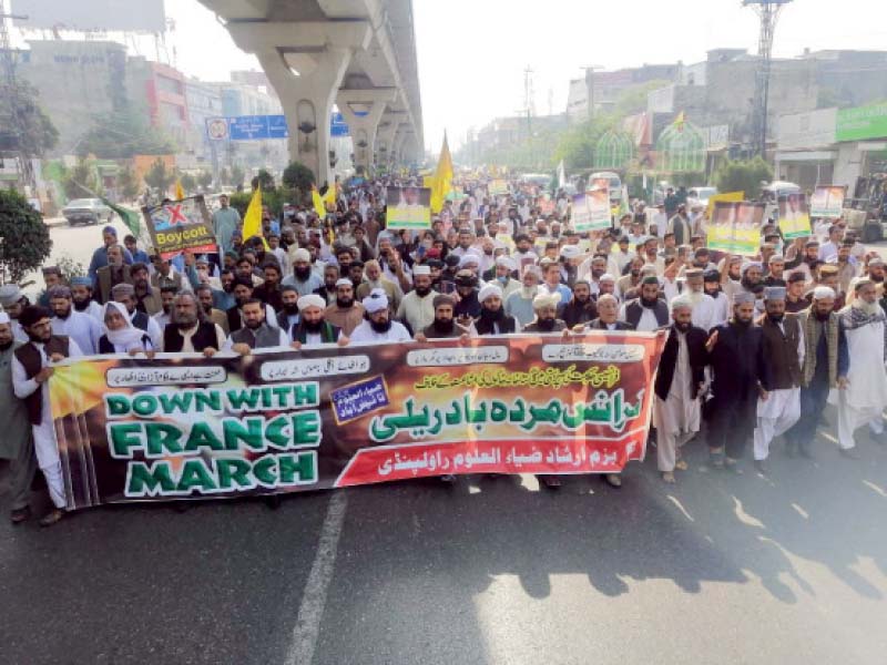 participants of a protest rally against blasphemous sketches pass through murree road in rawalpindi on wednesday photo jamil mirza express