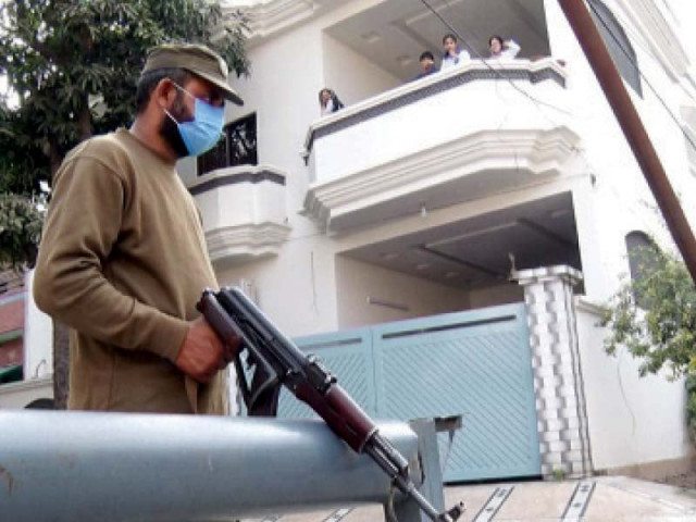 a policeman stands alert outside a house in iqbal town as the government imposed smart lockdown in the provincial capital photo express a policeman stands alert outside a house in iqbal town as the government imposed smart lockdown in the provincial capital photo express