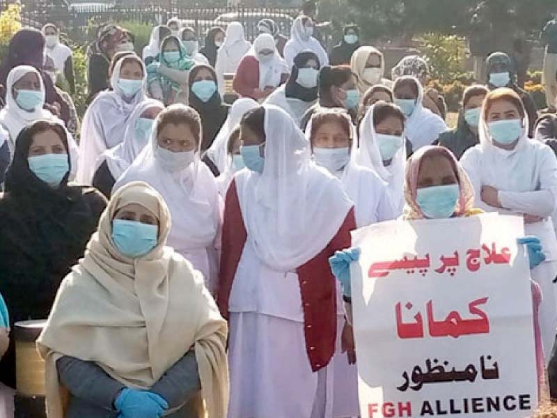 nurses and other medical staff of pims gather outside the hospital holding up placards against the imposition of the mti sys tem photo inp