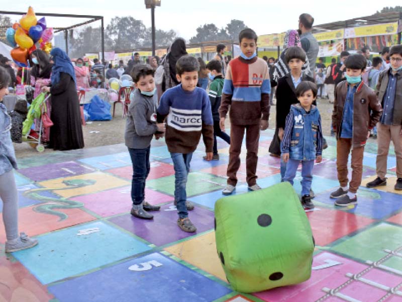 youngsters play on a life size ludo board as they enjoy their time on the second day of the tourism expo and family festival 2021 at the fatima jinnah park in the federal capital photo online