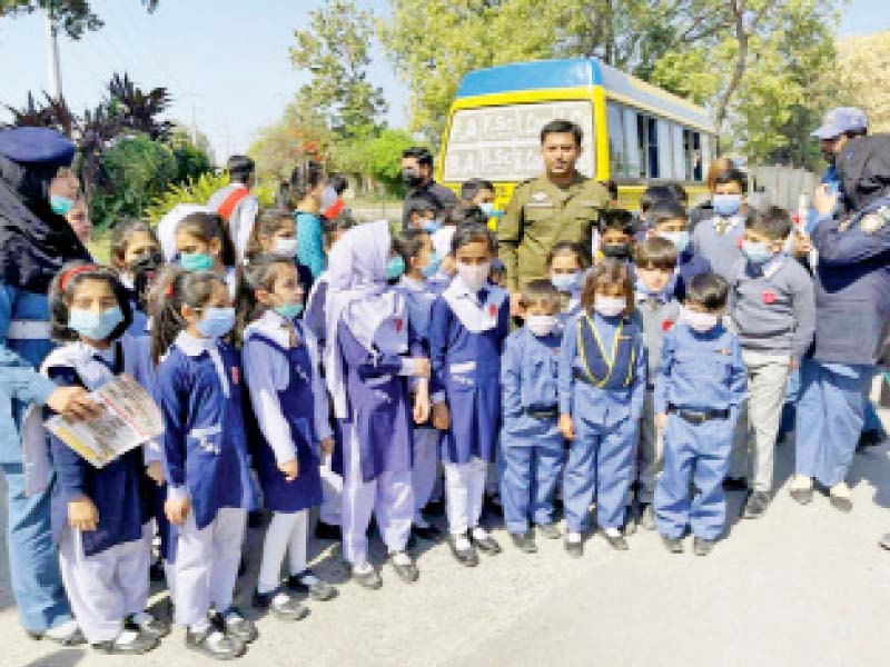 schoolkids pose with chief traffic officer rai mazhar during a training session on road safety rules in rawalpindi photo express