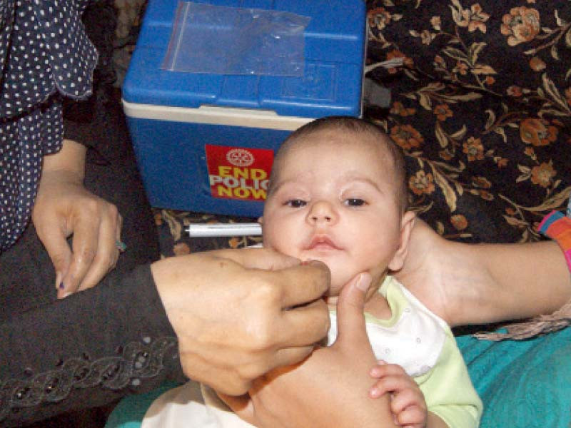 a health worker administers the oral polio vaccine to a child in rawalpindi on monday photo online