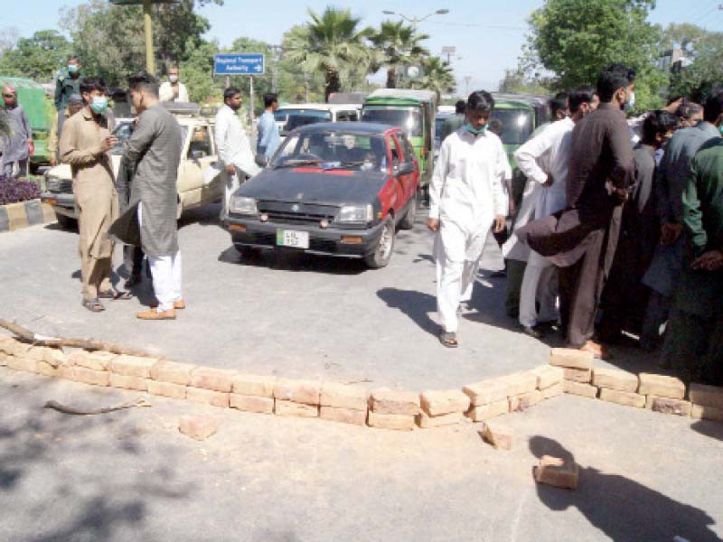 commuters were caught in a traffic jam as incensed transporters placed bricks to block the road outside the rta office in rawalpindi photo ppi