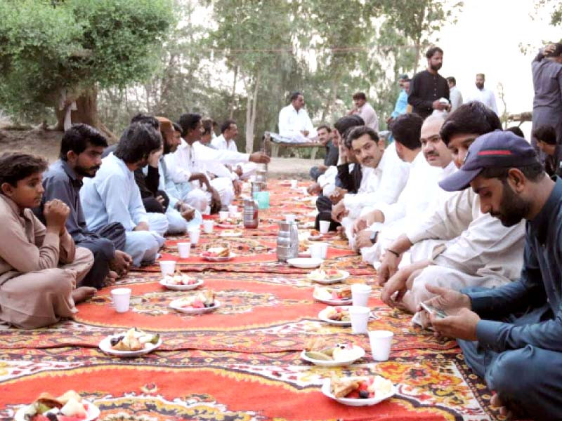 muslims from 22 villages in badin broke their fast at an iftar party organised by the area s hindu residents outside the shrine of sufi saint sandho wali on saturday photo courtesy mukesh meghwar