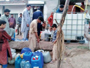 residents of dhok manshi filling their water canes at a tube well in rawalpindi photo agha mahroz express