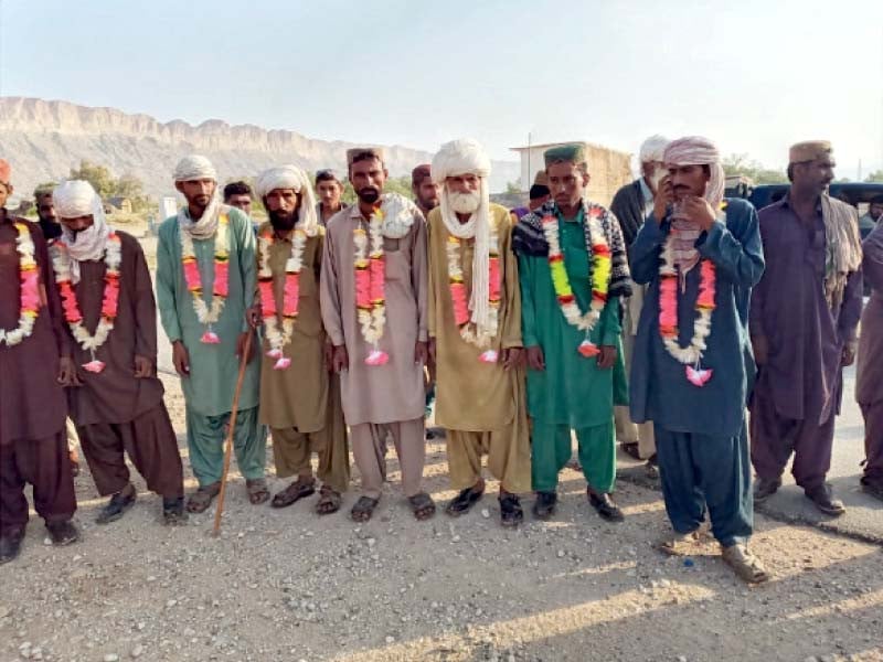 local tribesmen pose for a group photo upon their return to their ancestral village photo express