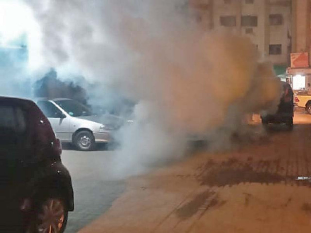 workers of clifton cantonment board busy in anti mosquito spray in the dha locality on friday evening photo express workers of clifton cantonment board busy in anti mosquito spray in the dha locality on friday evening photo express
