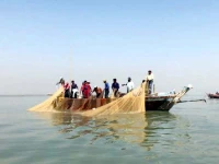 fishermen haul in a net on their boat photo anadolu agency