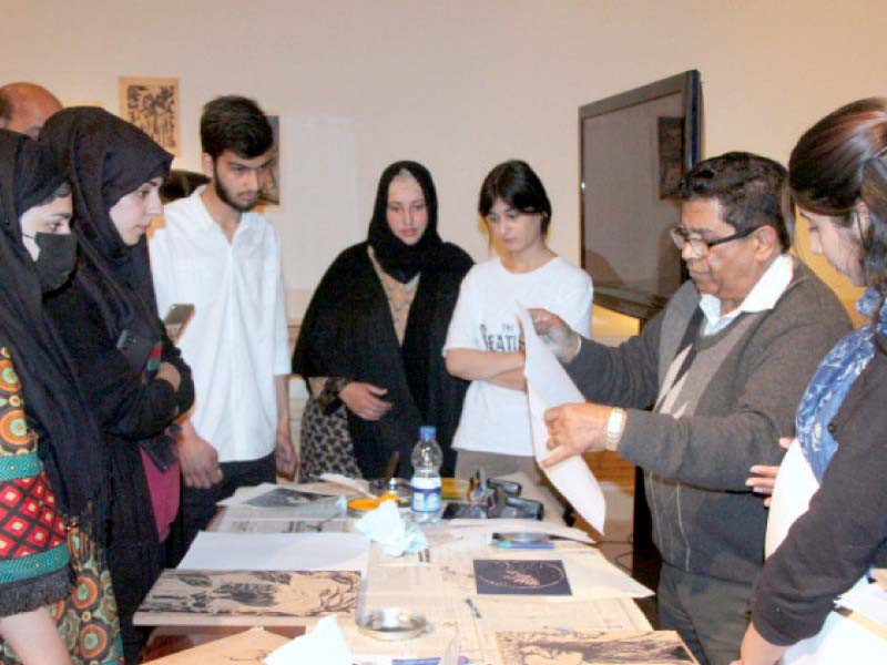 students and participants at the woodcutting workshop learn printing techniques at the pnca photo express