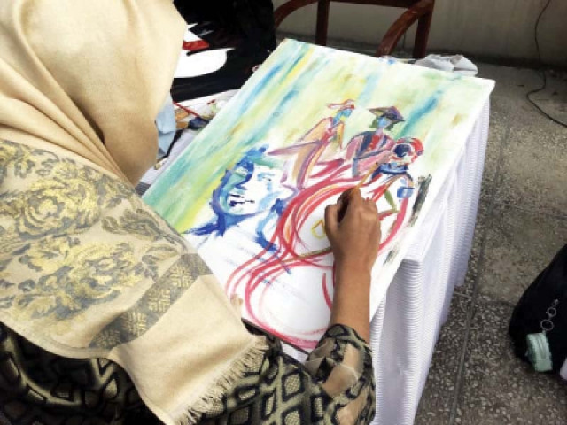 a girl makes a painting during the art competition to highlight women s issues photo express a girl makes a painting during the art competition to highlight women s issues photo express