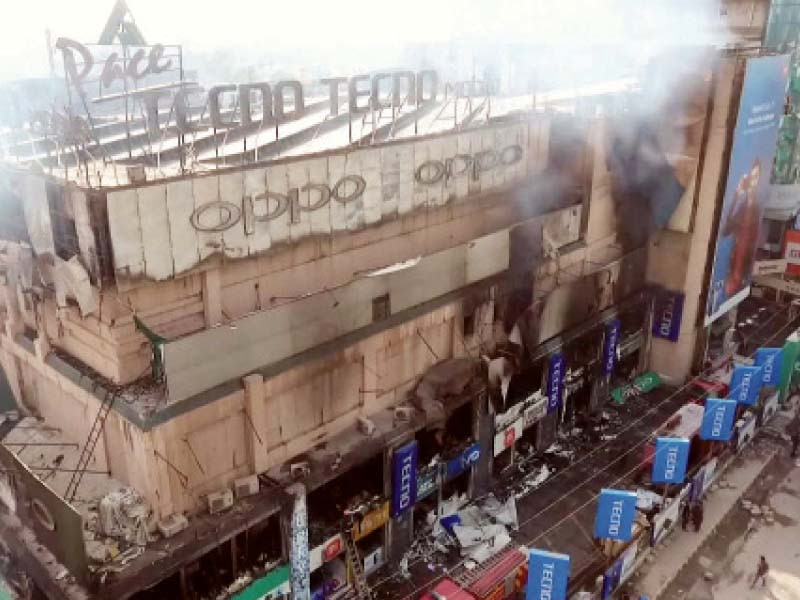 clouds of thick smoke billow from shops destroyed in a fire at pace shopping mall photo saeed anwar express