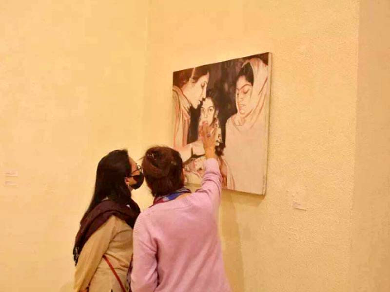 visitors take a keen interest in the artwork on display at satrang art gallery photo exprss