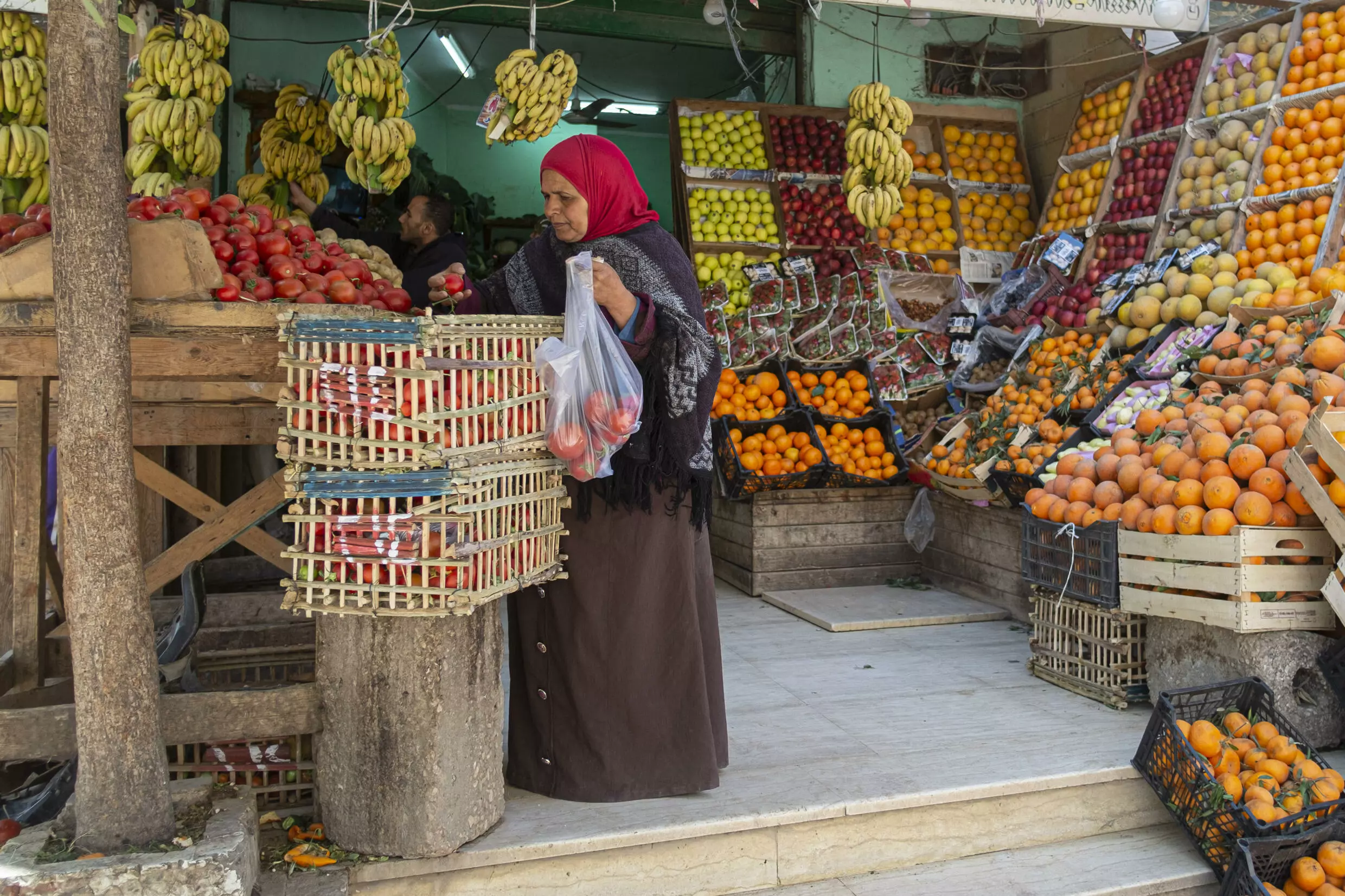 An Egyptian woman shops at a fruit market in Cairo. AFP