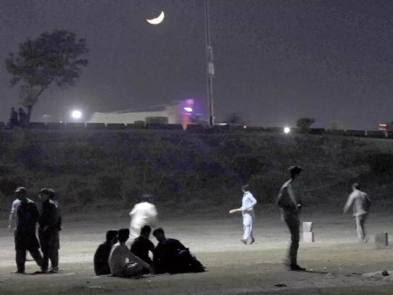 youngsters play a riveting game of night cricket under the streetlights next to the faizabad interchange in islamabad photo online youngsters play a riveting game of night cricket under the streetlights next to the faizabad interchange in islamabad photo online