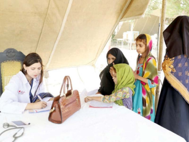 a doctor registers patients at a free medical camp in lodhran photo express a doctor registers patients at a free medical camp in lodhran photo express