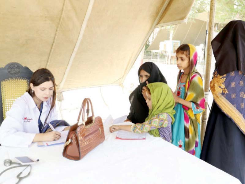 a doctor registers patients at a free medical camp in lodhran photo express