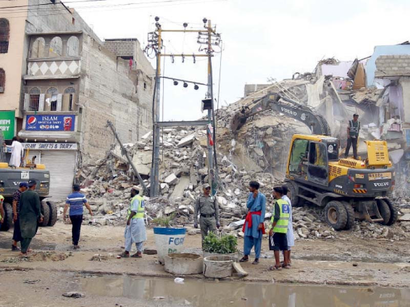 sindh building control authority officials remove debris of an illegal building which collapsed on monday morning photo jalal qureshi express