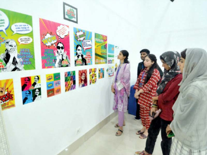 people admire the artwork of the students of arts council institute of arts and crafts which opened at the arts council of pakistan on monday photo express