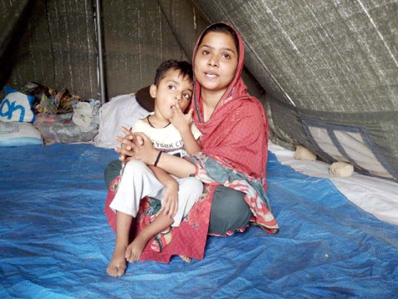 singer soonh laghari sits in a tent with her child at malir tent city photo express