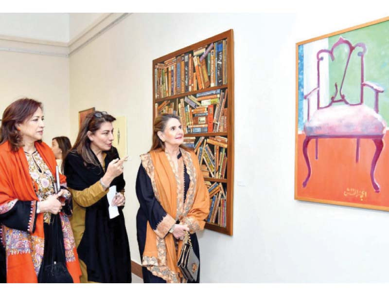 first lady begum samina arif alvi looks at the paintings on display at the pnca in islamabad photo ppi