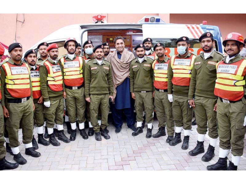 personnel of rescue 1122 flank ppp chairman bilawal bhutto zardari at the launch of the service in larkana photo express