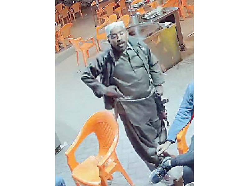 this screengrab from a cctv camera footage shows an armed suspect robbing people at a teashop in north nazimabad late on wednesday night photo express