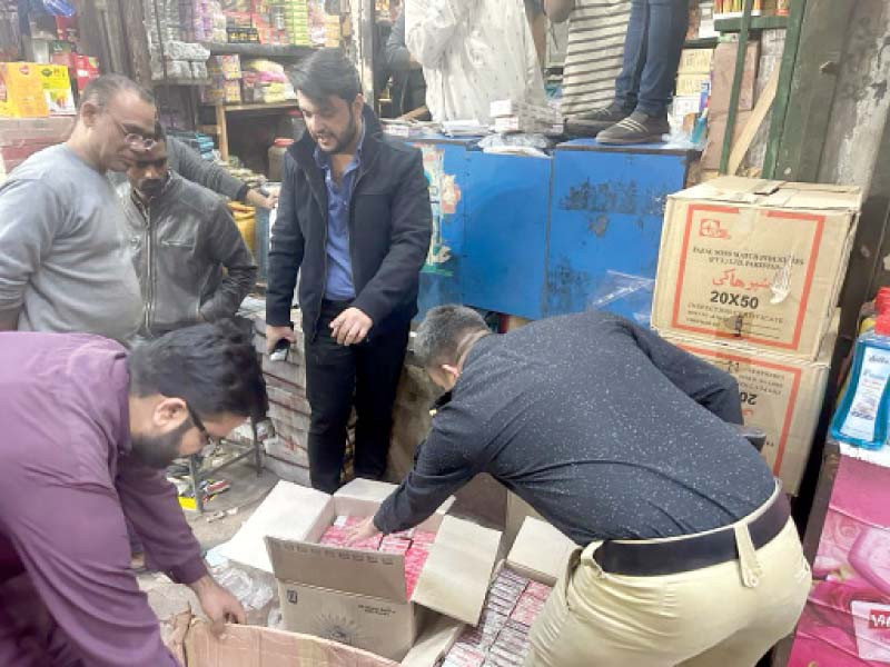 policemen seize illegal ciggereates during a raid at a warehouse in liaquatabad karachi photo express