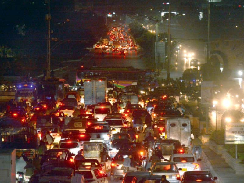 commuters are stranded due to a protest against the shortage of gas and power on korangi road photo express