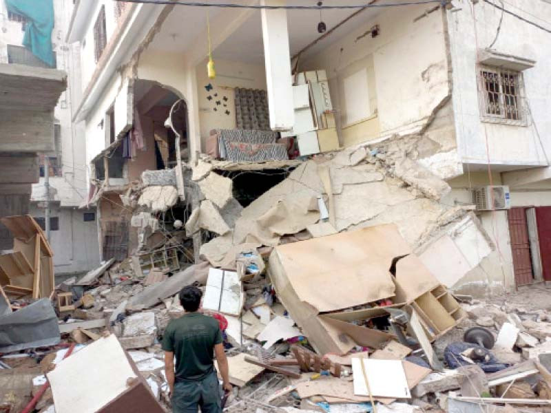 a man stands in front of a house which collapsed due to a gas explosion in fb area on friday photo ppi