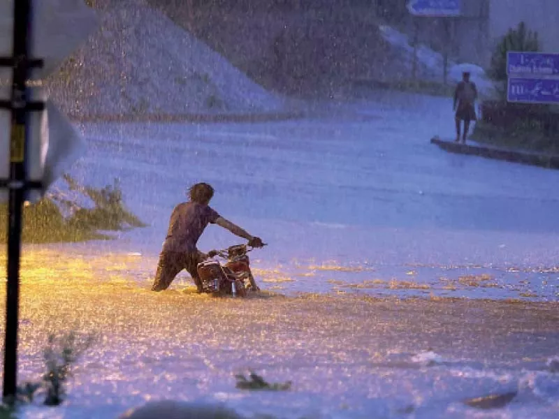 a motorcyclist wades through rainwater on a flooded road in the garrison city photos agha mehroz agencies a motorcyclist wades through rainwater on a flooded road in the garrison city photos agha mehroz agencies