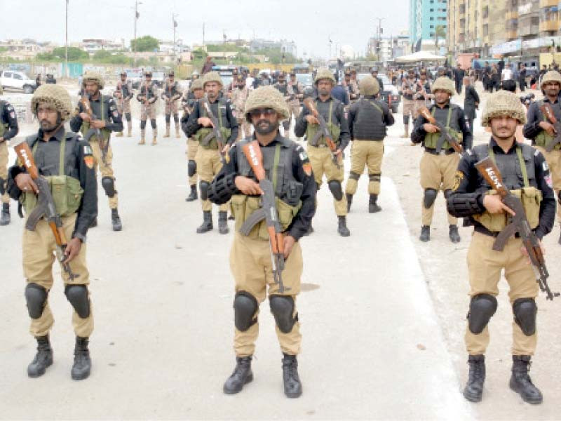 police guard the route of muharram 9 procession on ma jinnah road photo express