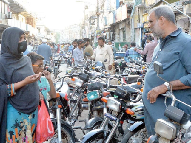 a woman begs for alms from a man at a market in karachi organised gangs of beggars have clearly demarcated areas in markets footpaths and signals photo jalal qureshi express a woman begs for alms from a man at a market in karachi organised gangs of beggars have clearly demarcated areas in markets footpaths and signals photo jalal qureshi express