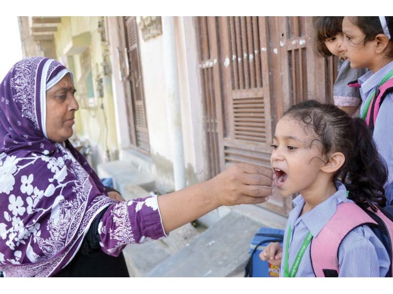 a health worker gives vitamin a supplement to a child along with polio vaccine during the ongoing inoculation drive photo jalal qureshi express