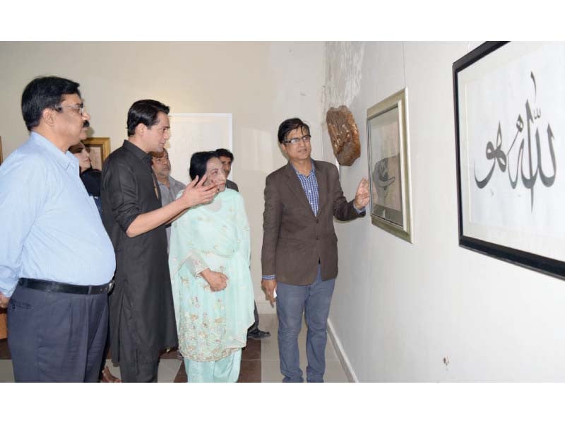 punjab arts council rawalpindi director waqar ahmed and guests take a keen interest in the islamic calligraphy exhibition that opened on wednesday photo express