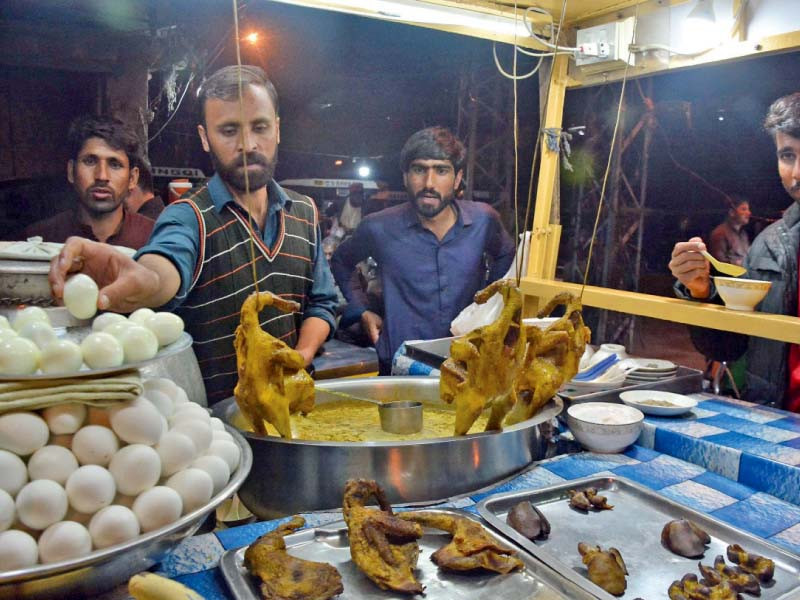 a vendor serves yakhni chicken soup to his customers at a roadside stall in the fawara chowk area of rawalpindi photo online