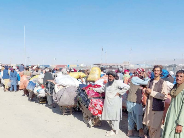 afghan refugees wait with their belongings to cross into afghanistan at the friendship gate of the chaman border crossing in balochistan photo reuters afghan refugees wait with their belongings to cross into afghanistan at the friendship gate of the chaman border crossing in balochistan photo reuters