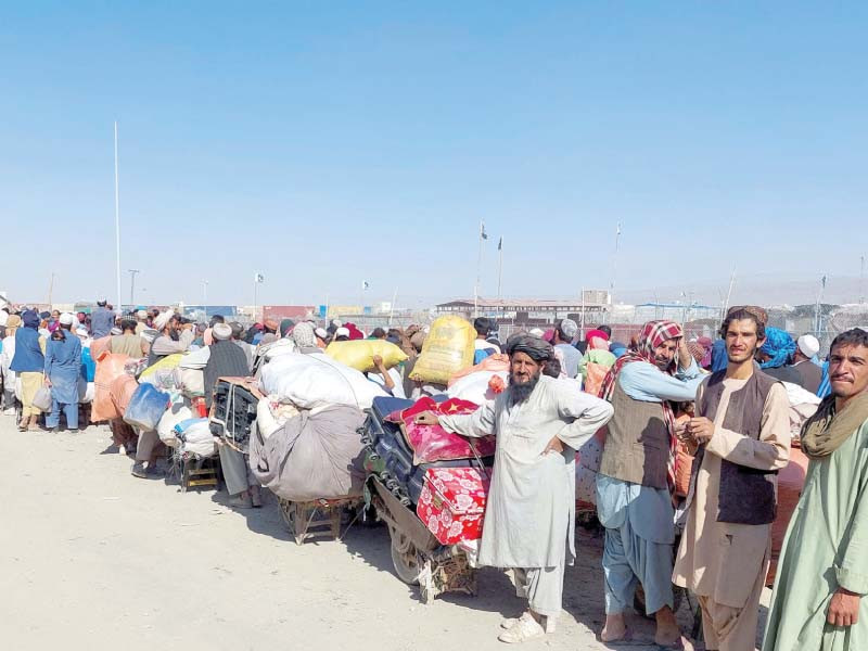 afghan refugees wait with their belongings to cross into afghanistan at the friendship gate of the chaman border crossing in balochistan photo reuters
