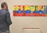 a visitor observes an art piece at an exhibition in the federal capital photo express